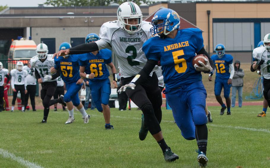 Ansbach's Yadiel Rodriguez heads toward the sideline as Naples' K.C. Evans tries to wrap him up during a meeting between the two teams in Ansbach, Germany on Saturday, Sept. 17, 2016. Ansbach won, 22-12. 