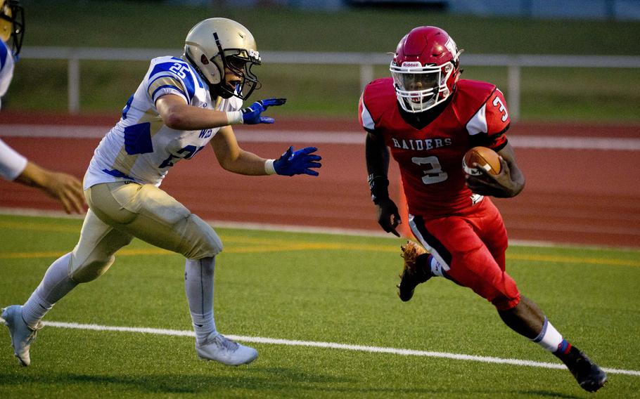 Kaiserslautern Raider Glenn Young runs past Wiesbaden Warrior Allen Quitagua in Kaiserslautern, Germany, on Friday, Sept. 23, 2016. The Raiders lost the game 26-7.