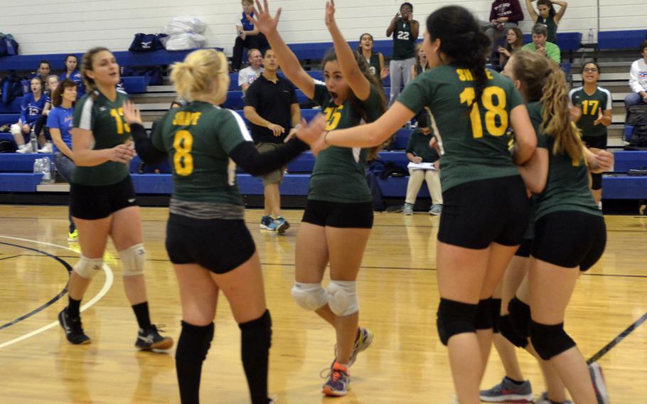 SHAPE volleyball players celebrate after winning two games in a row against Bitburg during a game at RAF Lakenheath, England, Saturday, Sept. 24, 2016. Bitburg eventually pulled-out a victory.