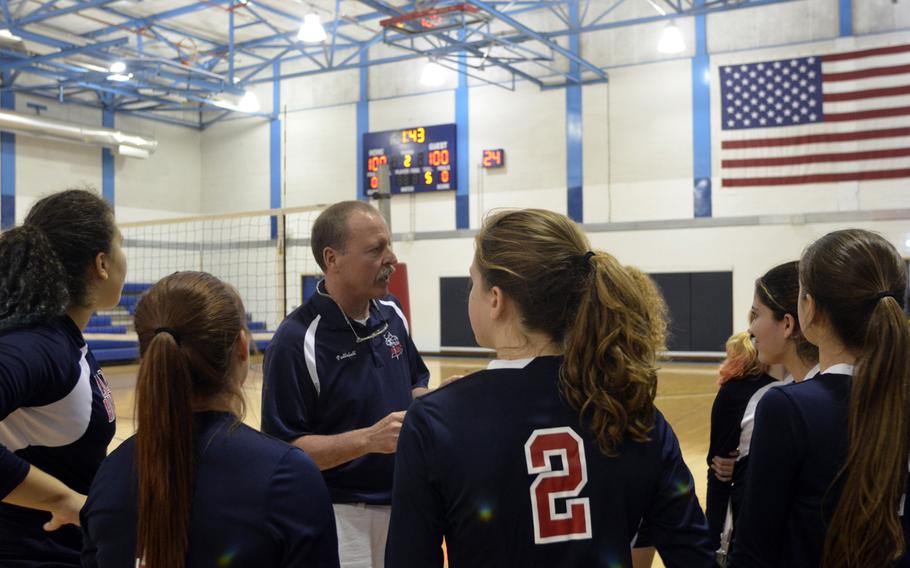 Bitburg coach Eric Vining talks strategy with his players during a timeout in a game against SHAPE at RAF Lakenheath, England, Saturday, Sept. 24, 2016. The Lady Barons earned a victory with a close win in the fifth game.