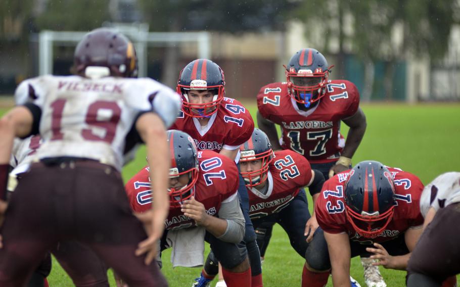 Lakenheath quarterback Tyler England leads his offense against Vilseck during a varsity football game at RAF Lakenheath, England, Saturday, Oct. 1, 2016. The Lancers beat Vilseck 14 to 7 in the pouring rain.
