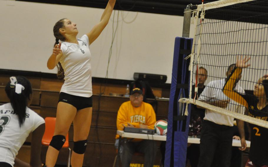 Naples senior Sierra Dye tips the ball back over the net in at match against Vilseck on Friday, Oct, 7, 2016. The Wildcats won to stay perfect on the season.