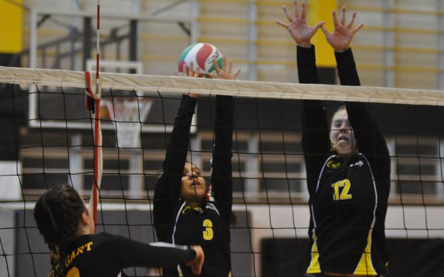 Stuttgart's Bella Brandt gets the ball by a block attempt by Vicenza's Gabriela Campos, center, and Adrianna Lovelace in the Panthers' victory Friday, Oct. 7, 2016.