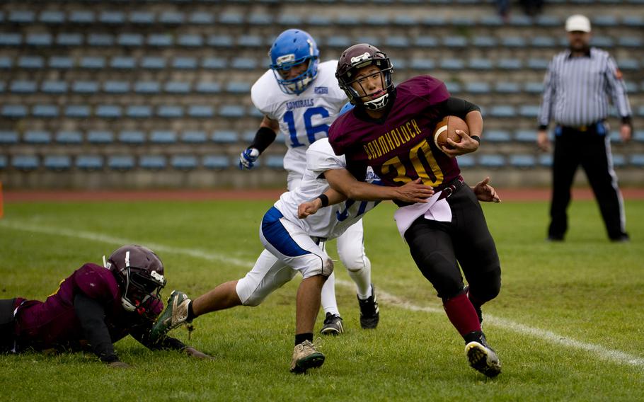 Baumholder's James Jin tries to break away from a tackle in Baumholder, Germany, on Saturday, Oct. 8, 2016. Baumholder lost to Rota 45-0.