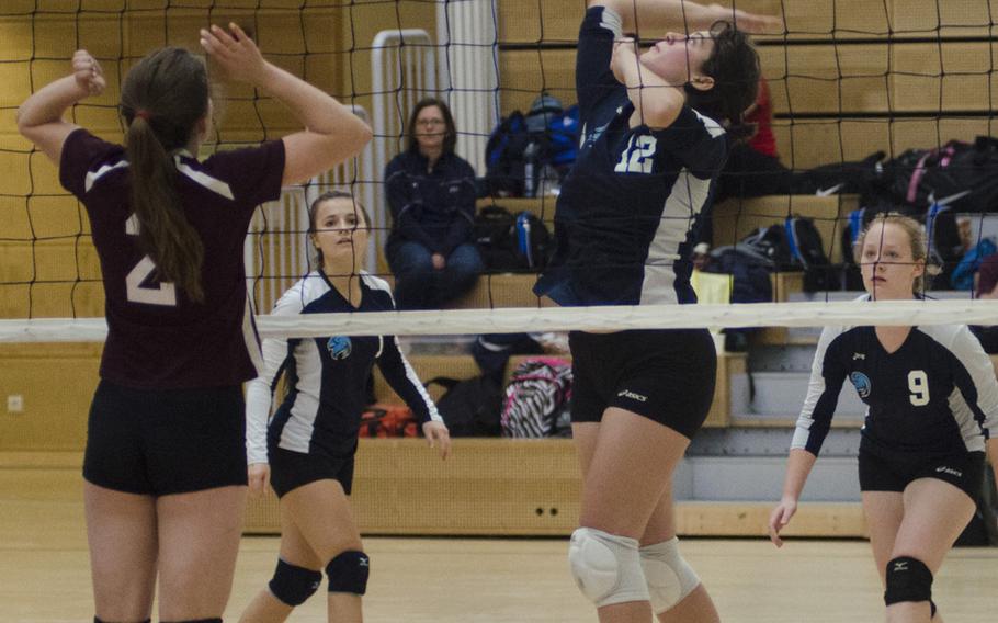 Brianna Maier of Black Forest Academy spikes the ball as Baumholder's Annabel Brinkmeyer attempts to block. BFA won the match in four sets, sending Baumholder home without a win in their two matches on the day.