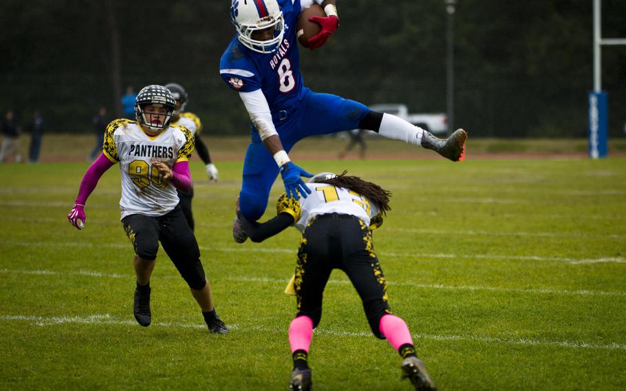 Ramstein's Brendan Hicks leaps over Stuttgart's Titus Best at Ramstein Air Base, Germany, on Saturday, Oct. 15, 2016. Ramstein won the game 29-0.