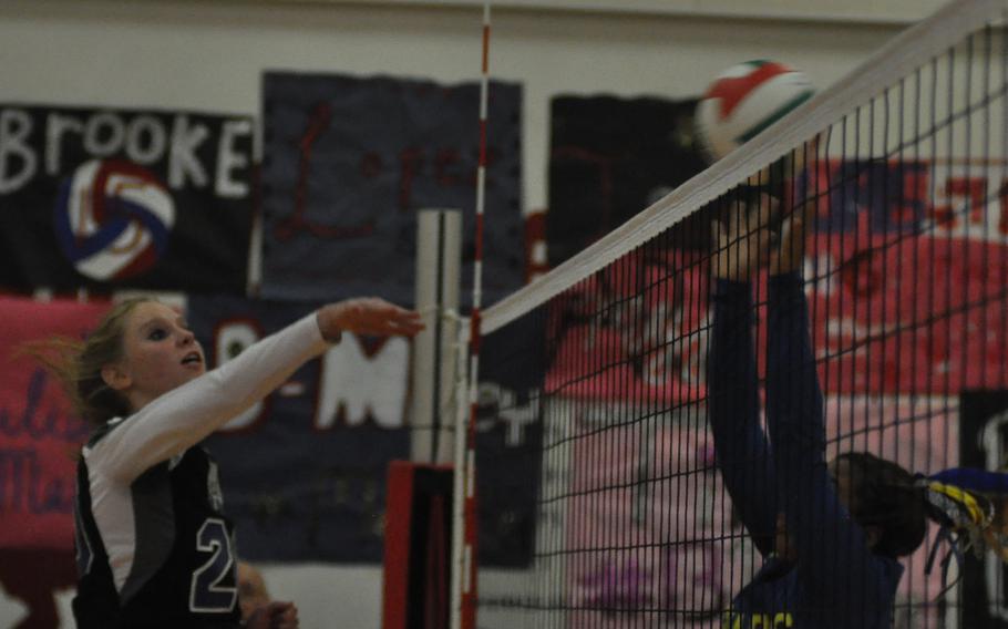 Hohenfels' Maddy Black hits the ball into a block from Sigonella's Kisiah Chandler on Friday night at Aviano Air Base, Italy.