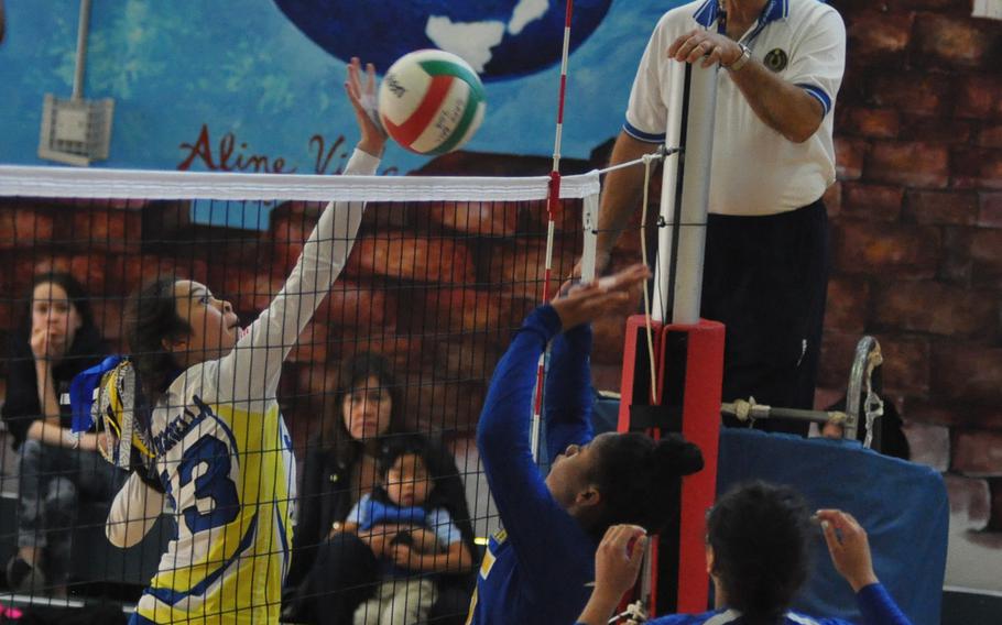 Sigoella's Kristiana Wyrick tips the ball over the net against Ansbach in a match Saturday morning at Aviano Air Base, Italy.