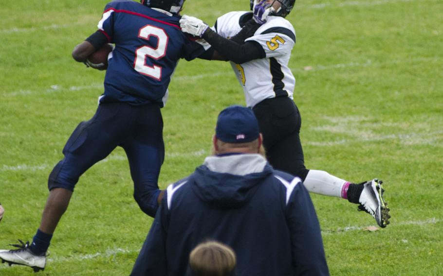 Javian Rouse of Bitburg stiff-arms Osaeon Diaz of Vicenza during a DODEA-Europe Division II quarterfinal matchup, Saturday, Oct. 22, 2016 at Bitburg, Germany. Bitburg won the game 40-0 behind a strong rushing attack and stifling defensive effort.