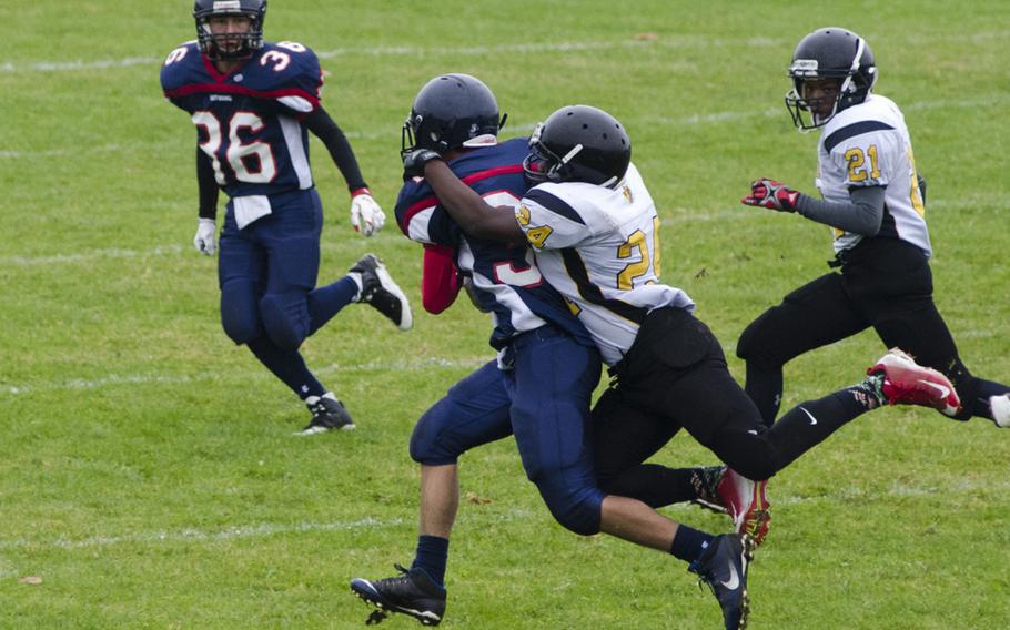 Arthur McDonald of Vicenza brings down Trey Bowles of Bitburg following Bowles' interception during a DODEA-Europe Division II quarterfinal matchup, Saturday, Oct. 22, 2016 at Bitburg, Germany. In addition to his interception, Bowles was Bitburg's primary receiving threat on offense in its 40-0 win.