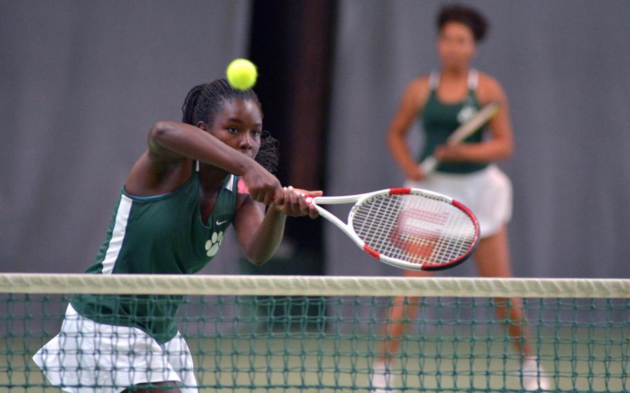 Naples' Jade Sawyer returns a ball at the net as teammate Lindsey Plavcan watches in their girls doubles match against Josephine Whalen and Anna McKenzie of Kaiserslautern. Naples won the exciting match 6-3, 6-7, 10-7.