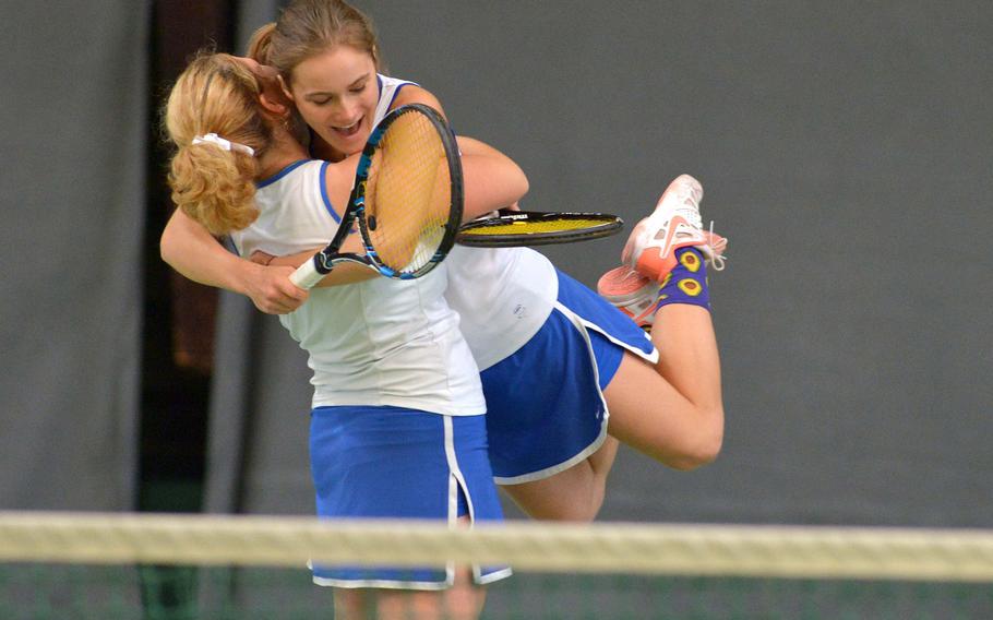 Ramstein's Amanda Daly lifts teammate Sophie Tomatz in the air after the pair defeated ISB's Brune Luciat-Labry and Hortense L'Hostis 2-6, 6-3, 6-2 in the girls doubles final at the DODEA-Europe tennis championships in Wiesbaden, Germany, Saturday Oct. 29, 2016. 