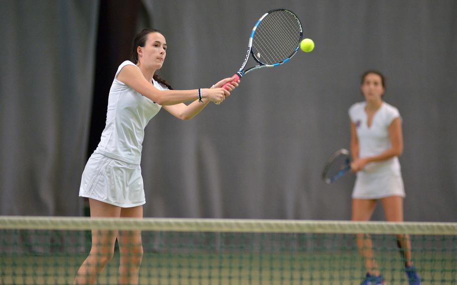 ISB's Brune Luciat-Labry returns a ball at the net as teammate Hortense L'Hostis watches, in the girls doubles final at the DODEA-Europe tennis championships in Wiesbaden, Germany, Saturday Oct. 29, 2016. The pair lost the match to Ramstein's Sophie Tomatz and Amanda Daly 2-6, 6-3, 6-1.