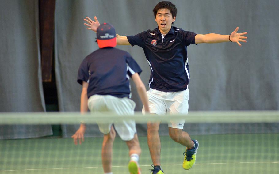 ISB's Victor della Faille runs to the outstretched arms of teammate Yuki Takeuchi after the pair defeated Ramstein's Ben Mouritsen and Grady Gallagher 6-3, 7-5 in the doubles final at the DODEA-Europe tennis championships in Wiesbaden, Germany, Saturday Oct. 29, 2016. 