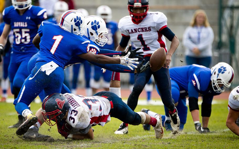 Ramstein's Jaylen Bussey, left, and Dawson Miskin lunge for a fumble at Ramstein Air Base, Germany, on Saturday, Oct. 29, 2016. Ramstein won the DODEA-Europe Division I semifinal game against Lakenheath 58-15.