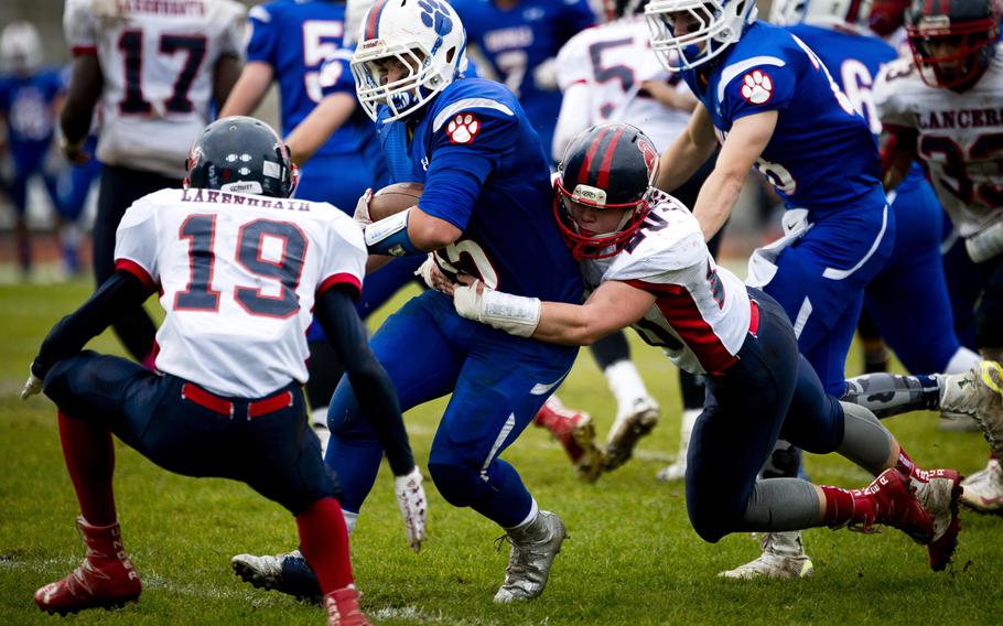 Ramstein's Andrew Short gets taken down by Lakenheath's Peyton Wilson during the DODEA-Europe Division I semifinal at Ramstein Air Base, Germany, on Saturday, Oct. 29, 2016. Ramstein won the game 58-15.