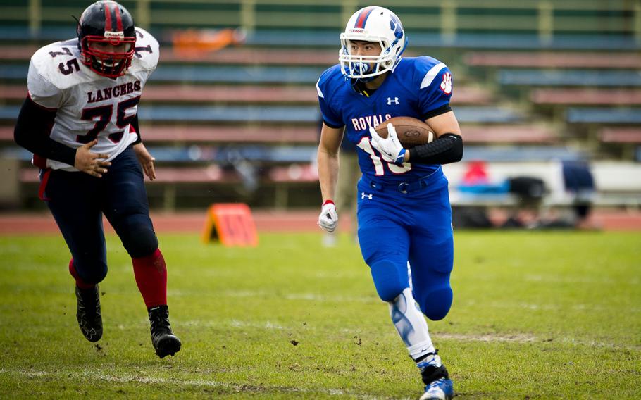 Ramstein's Sidney Boggs, right, runs past Lakenheath's Jacob Shankles during the DODEA-Europe Division I semifinal at Ramstein Air Base, Germany, on Saturday, Oct. 29, 2016. Ramstein won the game 58-15.