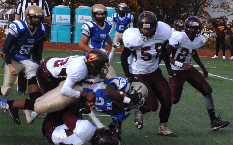 Wiesbaden running back Chris Hobson is brought down by a group of Vilseck tacklers in Wiesbaden's 20-17 semifinal win Saturday, Oct. 29, 2016, at Wiesbaden, Germany. 
