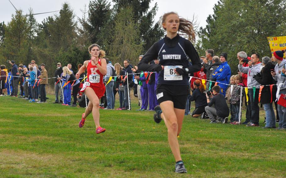 Kaiserslautern's Helene Arnold tries to catch Ramstein's Jordanne Hill down the final stretch on Saturday at the 2016 DODEA European cross country championships in Baumholder, Germany.