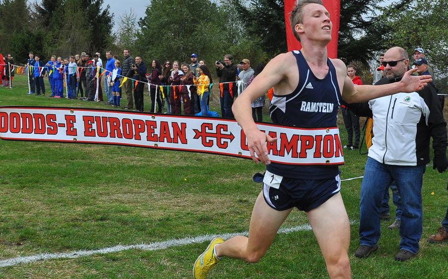 Ramstein's Colin McLaren breaks the finish tape first in the boys' race at the 2016 DODEA European cross country championships in Baumholder, Germany, on Saturday. McLaren set a new course record of 16:27.03 on the 5-kilometer course, helping the Royals win the Division I boys' title.