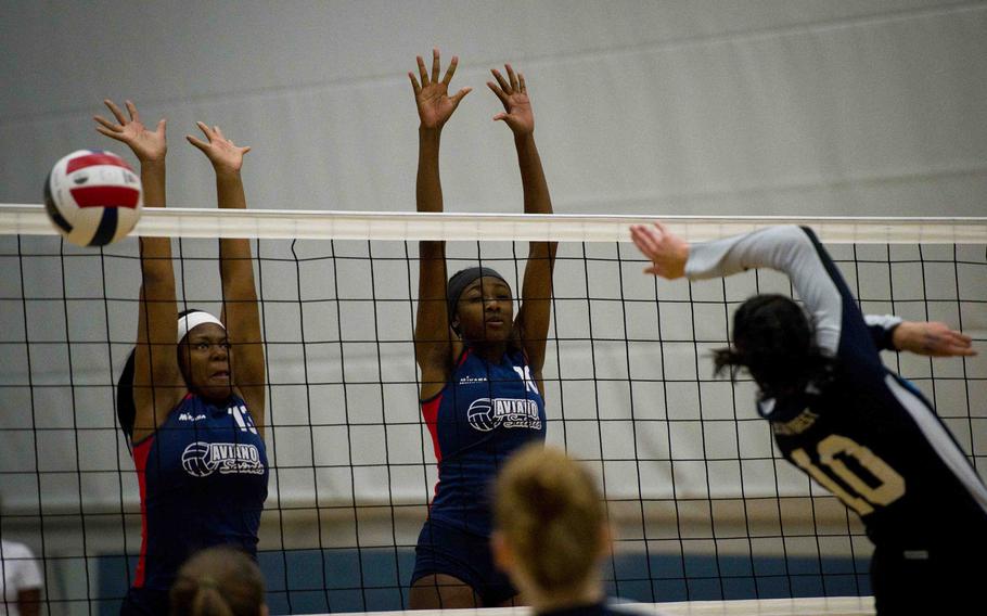 Aviano's Tih Cottingham, left, and De'Jah Tripp try to block Black Forest Academy's Erin Fortune during the DODEA-Europe semifinals at Vogelweh, Germany, on Friday, Nov. 4, 2016. Aviano lost 24-26, 25-20, 25-9 and 25-14.