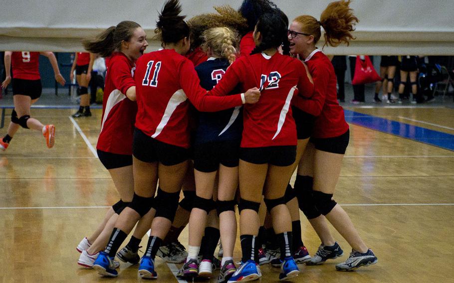 Bitburg celebrates winning a DODEA-Europe Division II semifinal match against Bahrain at Vogelweh, Germany, on Friday, Nov. 4, 2016. Bitburg won 23-25, 25-15, 21-25, 25-8 and 15-6.