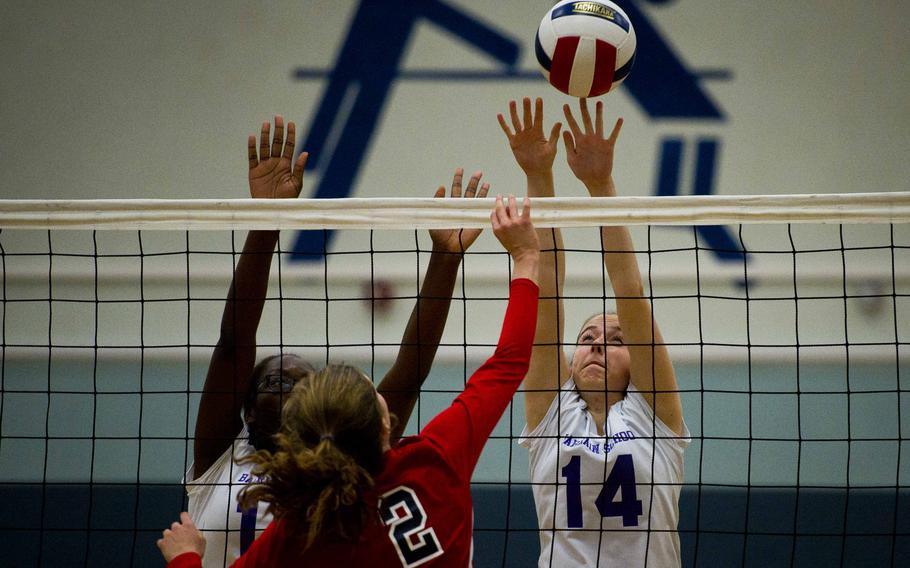 Bahrain's Zoie Howes, right, and Tofunmi Sodeinde try to block Bitburg's Hannah Bissonnette, at Vogelweh, Germany, on Friday, Nov. 4, 2016. Bahrain lost 23-25, 25-15, 21-25, 25-8 and 15-6.