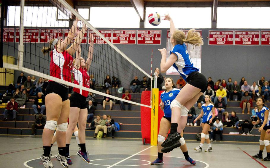 Vicenza's Adrianna Lovelace, left, and Wiesbaden's Brigantia O'Sadnick jump to block a spike by Alconbury's Ashlyn Starr during a DODEA-Europe Volleyball All-Star match in Kaiserslautern, Germany, on Saturday, Nov. 12, 2016.