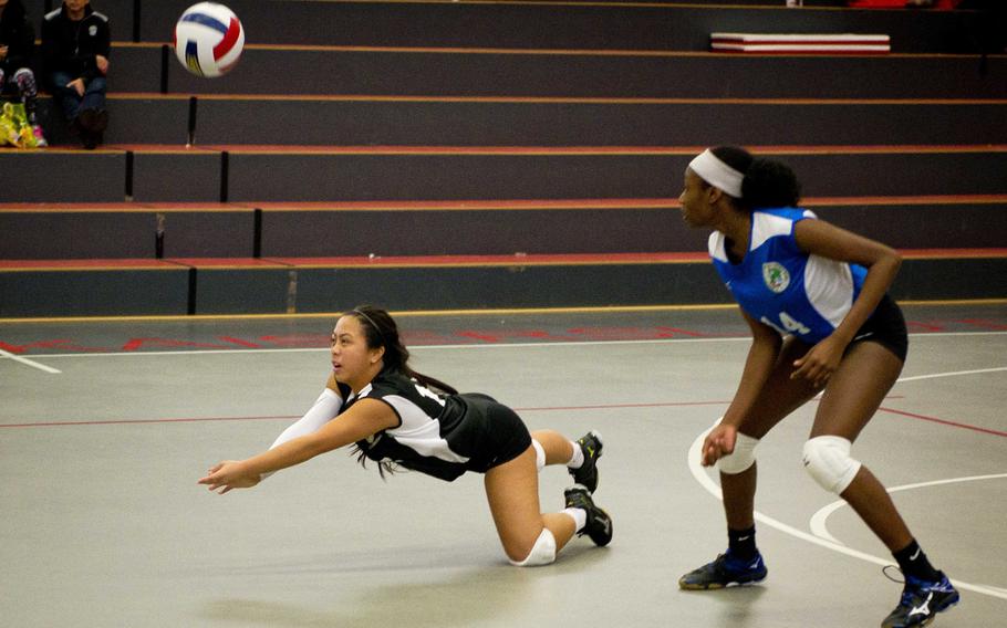 Ramstein's Cristeana Reyes, left, dives for the ball as Aviano's De'Jah Tripp watches in Kaiserslautern, Germany, on Saturday, Nov. 12, 2016.