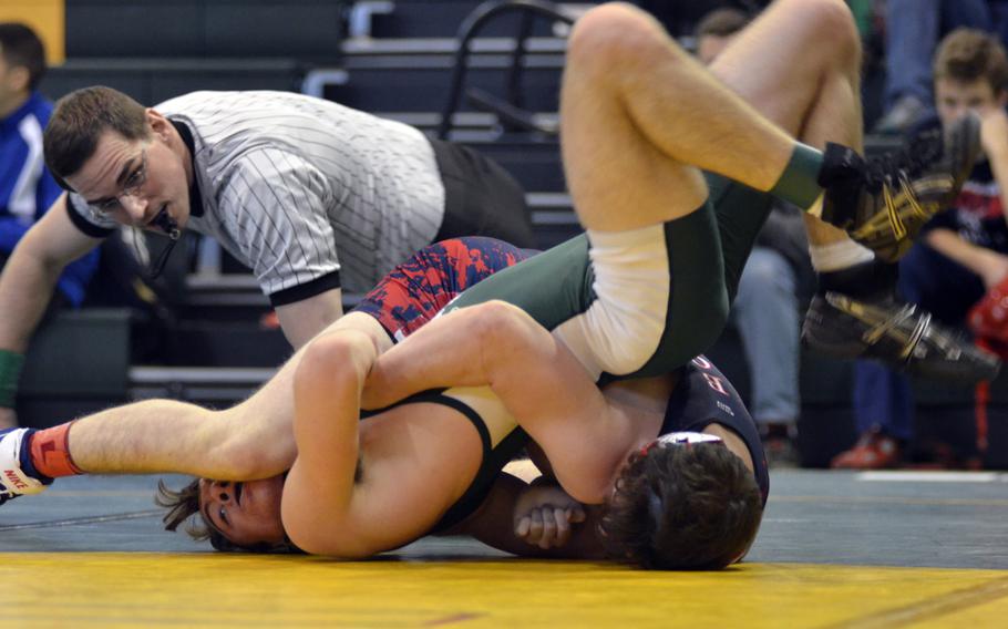 Veteran Lakenheath wrestler Preston Booth pins Alconbury's CJ Koloshky during the first high school tournament of the season at RAF Alconbury, England, Saturday, Dec. 3, 2016. 