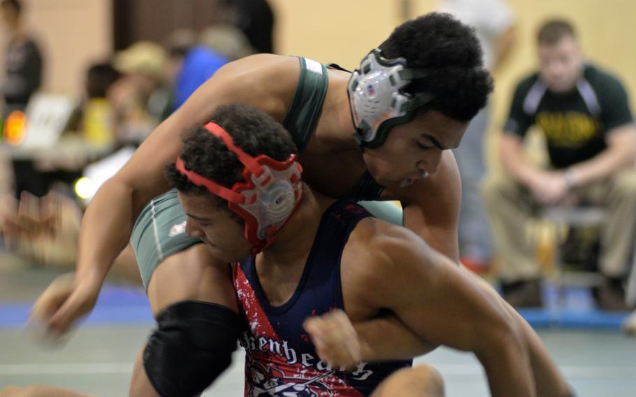 Alconbury wrestler Dee Wilson dominates in his match against Lakenheath's Daniel Holland at 170 pounds during the first high school tournament of the season at RAF Alconbury, England, Saturday, Dec. 3, 2016.