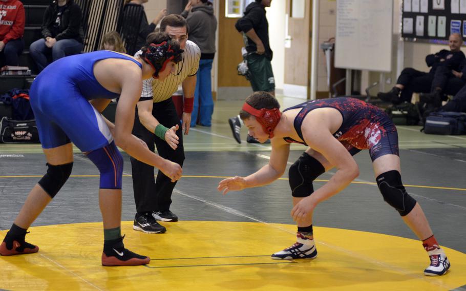 Lakenheath wrestler Joseph Krussick prepares to shoot for Brussels wrestler Oleksandr Orativskyi's right leg during the first high school wrestling tournament of the season at RAF Alconbury, England, Saturday, Dec. 3, 2016.