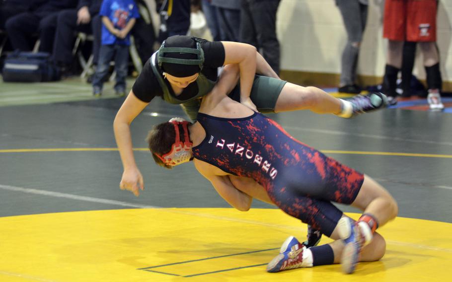 Lakenheath wrestler Jacob Brown takes down Alconbury's Vivian Newcomer during the first high school wrestling tournament of the season at RAF Alconbury, England, Saturday, Dec. 3, 2016.