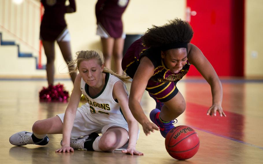 Baumholder's Tytianna Martinez, right, dives for the ball past Alconbury's Marissa Kastler in Baumholder, Germany, on Saturday, Dec. 10, 2016. Baumholder won the game 31-12.