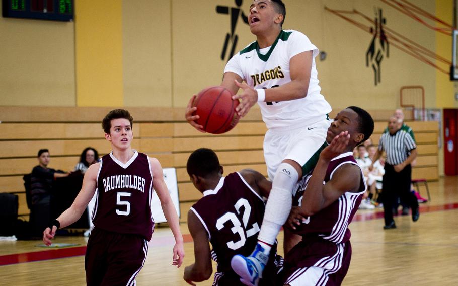 Alconbury's Anthony Stewart goes for a layup over Baumholder's defense in Baumholder, Germany, on Saturday, Dec. 10, 2016. Alconbury lost the game 61-36.