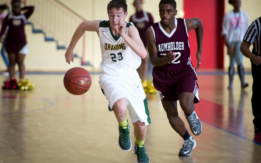 Alconbury's Tyler Gilhuys, left, and Baumholder's Michael Fleming race for the ball in Baumholder, Germany, on Saturday, Dec. 10, 2016. Alconbury was defeated 61-36.