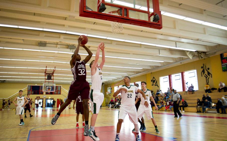 Baumholder's Michael Fleming, left, goes for a shot in Baumholder, Germany, on Saturday, Dec. 10, 2016. Baumholder defeated Alconbury 61-36.