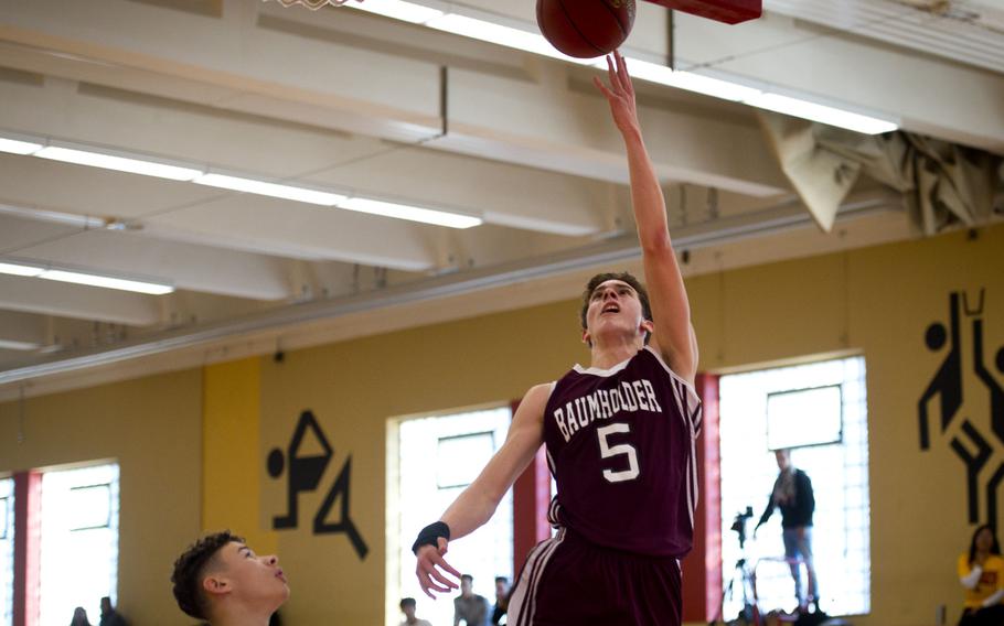 Baumholder's Lester Jungbluth, right, goes for a layup over Alconbury's Jose Cordero in Baumholder, Germany, on Saturday, Dec. 10, 2016. Baumholder won the game 61-36.