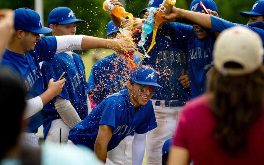 The Rota Admirals pour Gatorade on Trayton Luna in celebration of his game-winning run after the DODEA-Europe Division II/III baseball championship at Ramstein Air Base, Germany, on Saturday, May 28, 2016. Rota defeated the Bitburg Barons 5-4 to win the title.