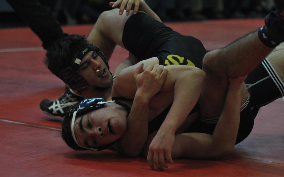 Munich International's Cole Ronnau, left, stayed unbeaten by getting past Vicenza's Ethan Johnston, but it wasn't easy. Ronnau earned a 14-11 decision at 170 pounds in the seven-team meet at Aviano Air Base, Italy.