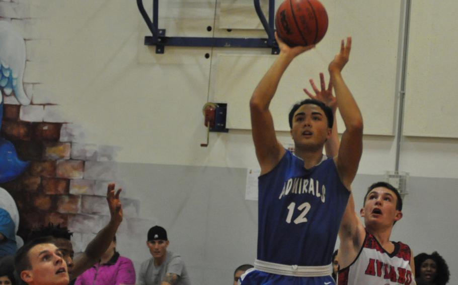 Rota's Jake Anderson gets up a shot Thursday, despite Aviano's Mason Shine trying to get a hand in the way in the Admirals' 63-23 victory in Italy.