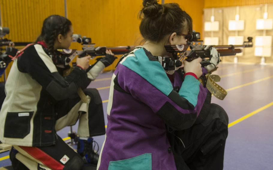 Victoria Jackson, left, and Renee Sahli, both of Kaiserslautern, prepare to fire during the kneeling portion during a conference marksmanship competition in Wiesbaden, Saturday, Jan. 21, 2017. Jackson and Sahli were the top two shooters, finishing with 281 and 276, respectively.