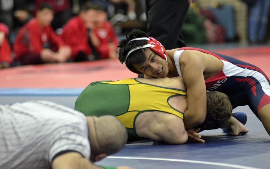 Bitburg wrestler Kurt Nacionales works for a pin against SHAPE's Alex Kimberly during the northern sectionals at RAF Lakenheath, Saturday, Feb. 11, 2017.