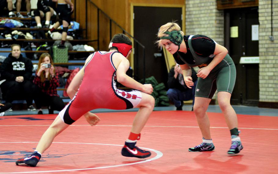 Kaiserslautern wrestler Kevin Larson shoots against Alconbury's Vivian Newcomer during the northern wrestling sectionals at RAF Lakenheath, Saturday, Feb. 11, 2017. 