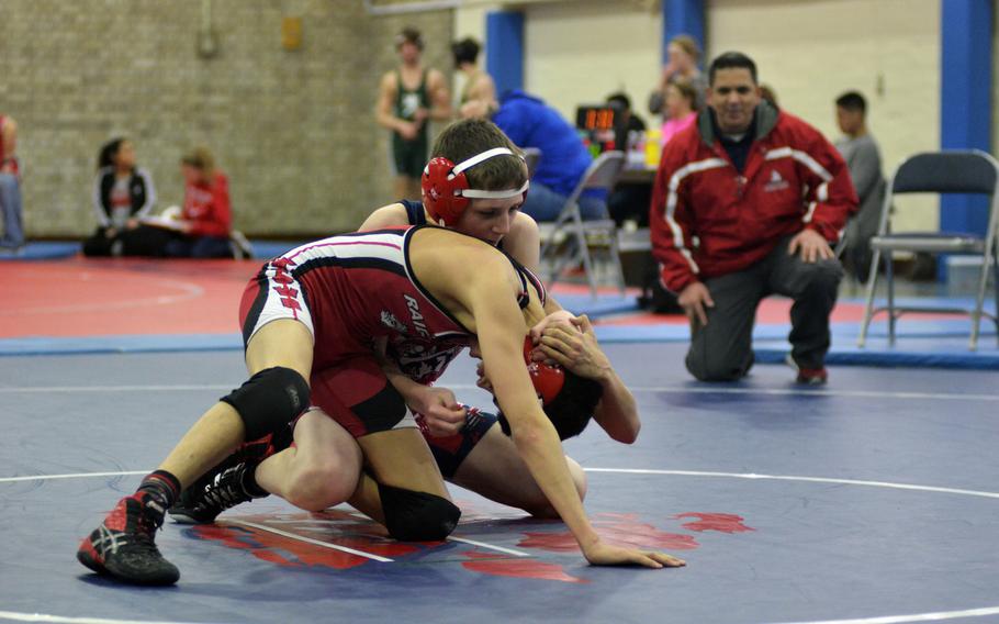 Lancer wrestler Eli Rothas works against Kaiserslautern's Zahn Delgado in the 106-pound weight class during the Northern wrestling sectionals at RAF Lakenheath, Saturday, Feb. 11, 2017.