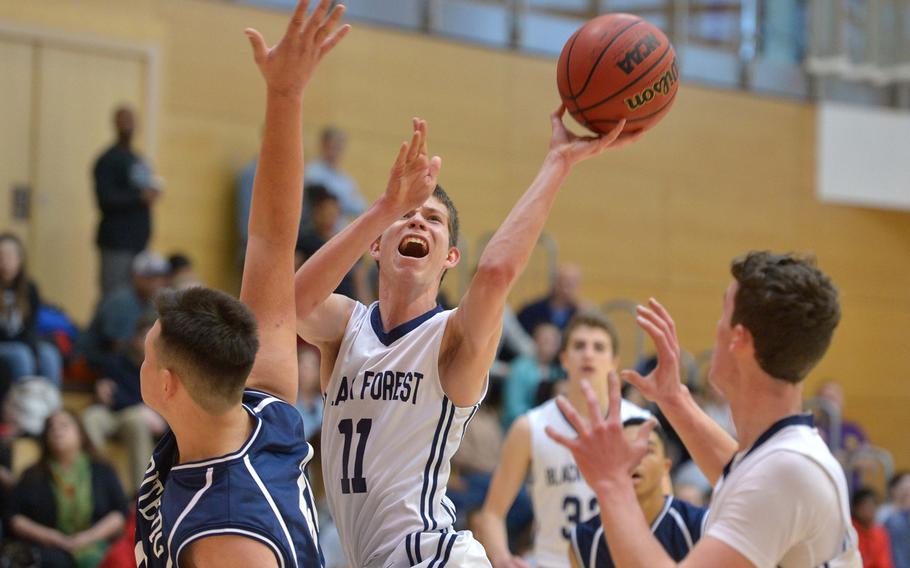Black Forest Academy's Trevor Braaten goes in for a basket in the Falcon's 72-50 win over Bitburg in opening-day Division II action at the DODEA-Europe basketball championships in Wiesbaden, Germany, Wednesday, Feb. 22, 2017.