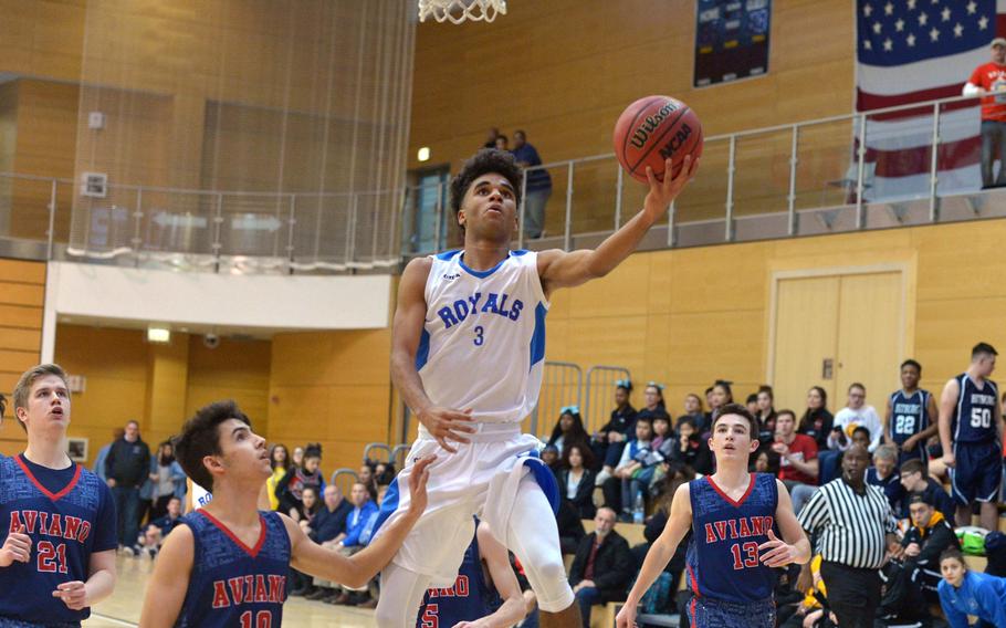 Marymount's Dominic Laffitte goes in for a basket past Aviano's Hayden Roers in opening-day Division II action at the DODEA-Europe basketball championships in Wiesbaden, Germany, Wednesday, Feb. 22, 2017. Laffitte had 35 points in the Royals' 49-46 loss, while Roers led the Saints with 20 points.