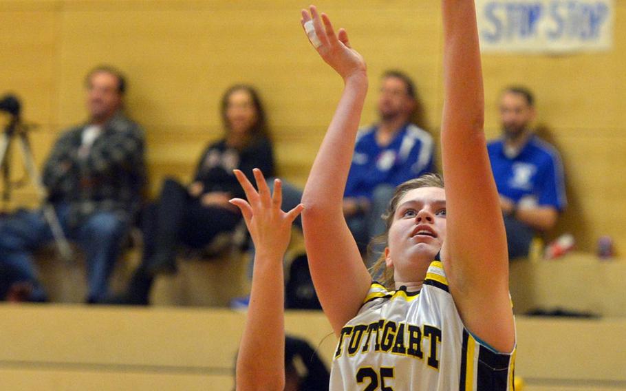 Stuttgart's Allyson Taylor shoots over SHAPE's Nicole Shoaf in opening-day Division I action at the DODEA-Europe basketball championships in Wiesbaden, Germany, Wednesday, Feb. 22, 2017. Stuttgart won the game 34-18.