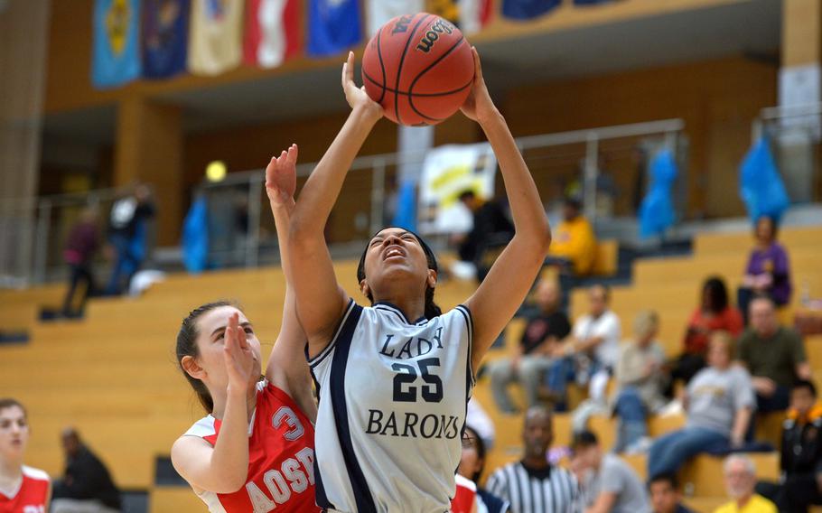 Bitburg's Amadi Bradshaw goes to the hoop against AOSR's Denise Rapp in a Division II semifinal at the DODEA-Europe basketball championships in Wiesbaden, Germany, Friday, Feb. 24, 2017. Bitburg won the game 36-12 to advance to Saturday's final against Black Forest Academy.