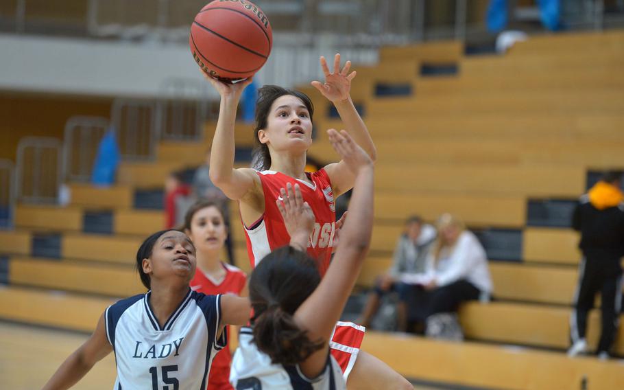 American Overseas School of Rome's Anne Blanchette looks for a shot against Bitburg's Laila Brown, left, and Alyssa Aguire in a Division II semifinal at the DODEA-Europe basketball championships in Wiesbaden, Germany, Friday, Feb. 24, 2017. Bitburg won the game 36-12 to advance to Saturday's final against Black Forest Academy.